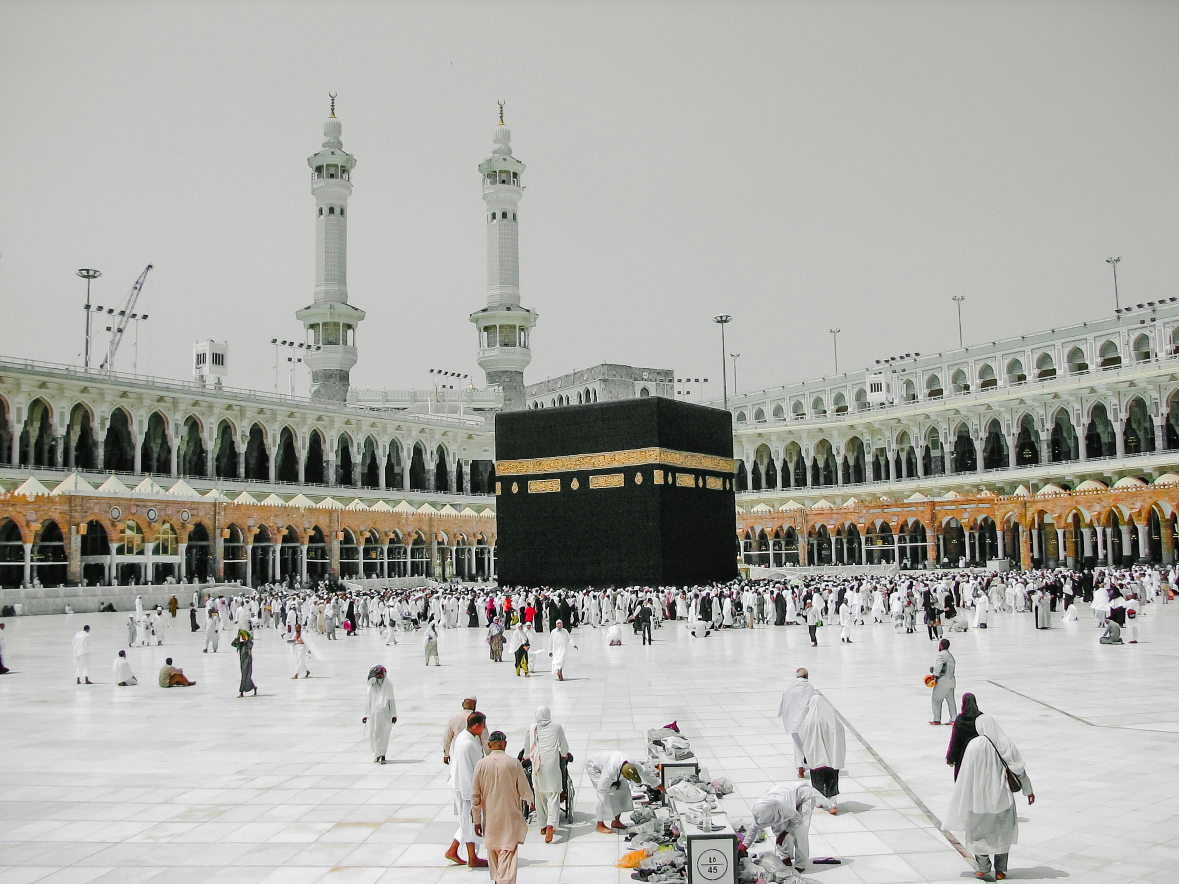 The Kaaba and the courtyard of Masjid al-Haram with pilgrims